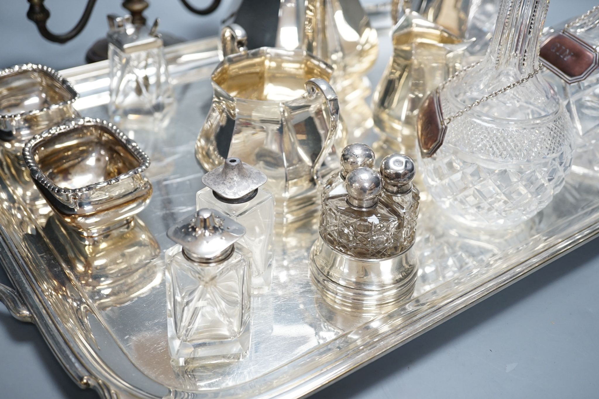 A quantity of silver plated tea/coffee wares including two handled tray, decanters, salts etc., 62cm